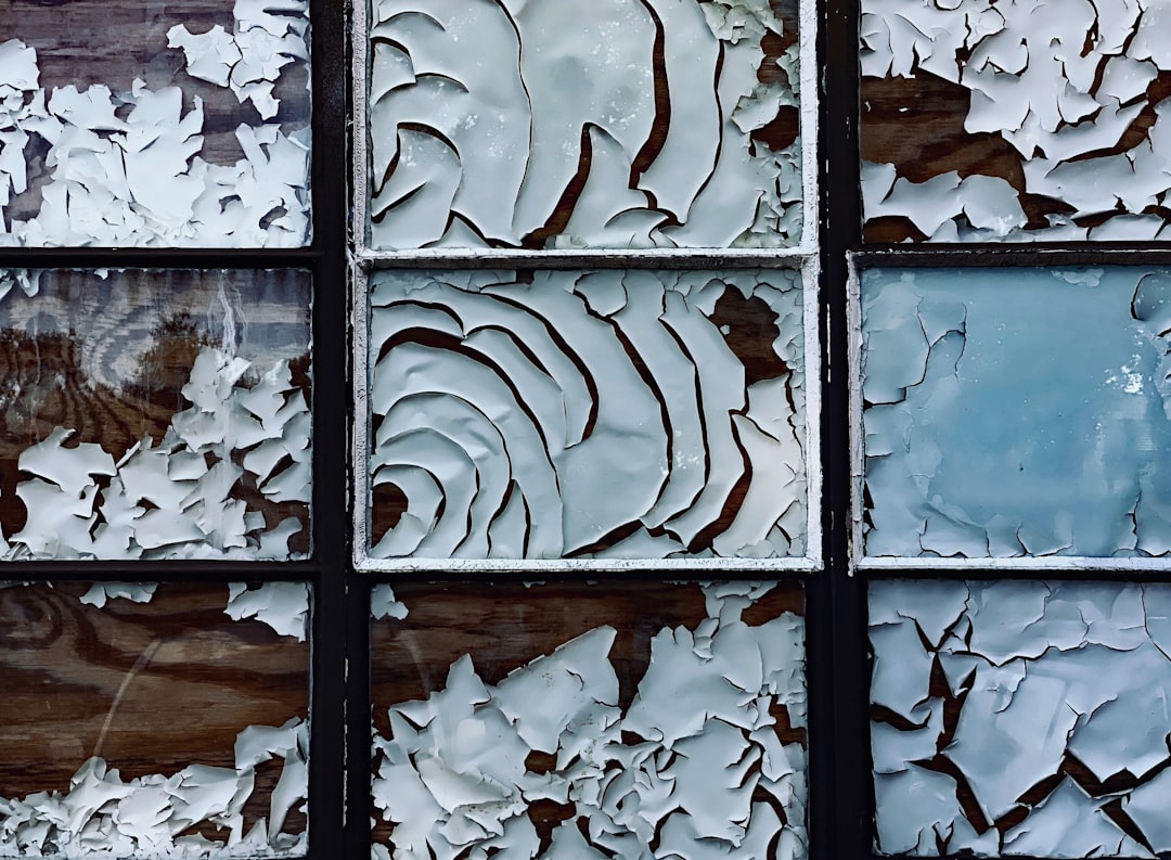 white paper decaying in boarded up window